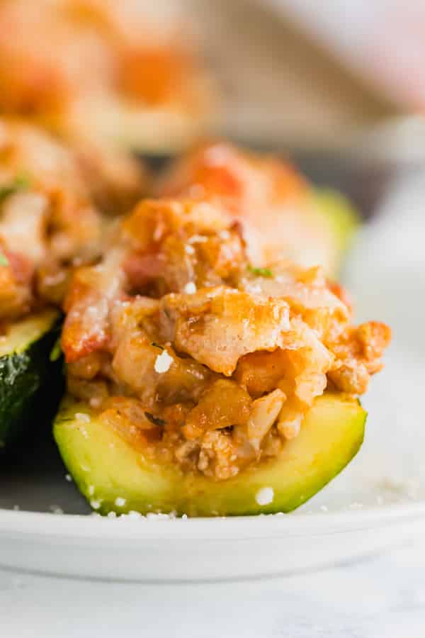 A straight-on close up shot of the inside of stuffed zucchini boats.