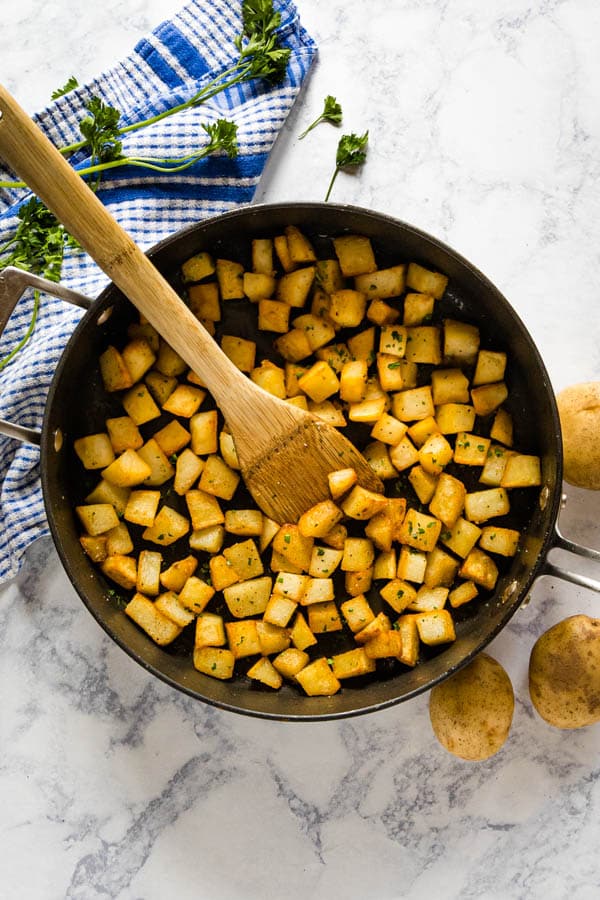 An overhead image of a pan full of fried potatoes