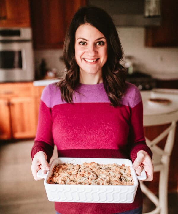 A woman holding a casserole.