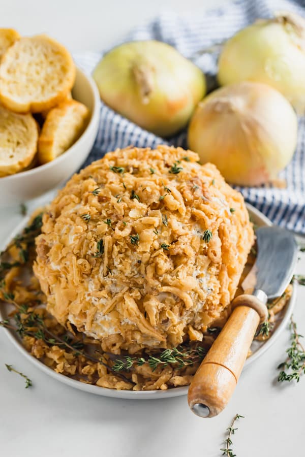 A French onion cheeseball on a plate.
