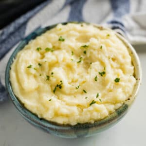 Is it even a holiday dinner without mashed potatoes?! I say, ditch the hassle and make these easy Make Ahead Mashed Potatoes recipe. Made with cream cheese and sour cream, they're creamy, flavorful and totally delicious!