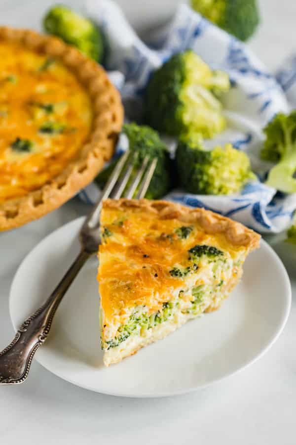A slice of quiche on plate.