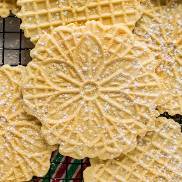 This Italian Pizzelle recipe is a classic Christmas cookie flavored with either vanilla or anise that we all know and love. They're super easy to make with a light and slightly crispy texture you won't be able to get enough of this holiday season!