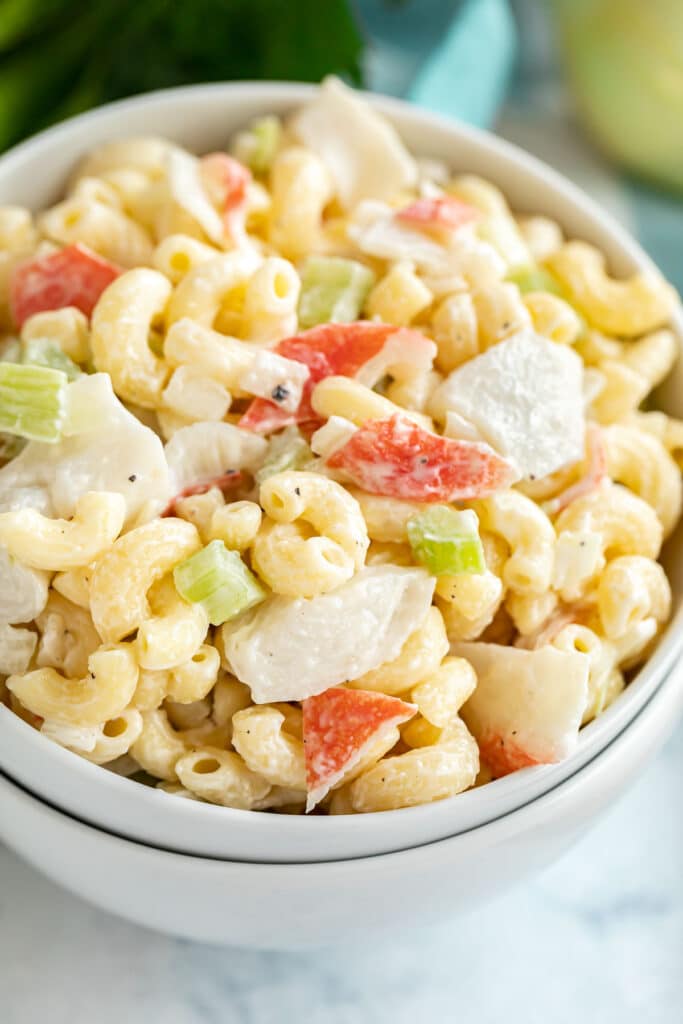 A close up of this crab macaroni salad recipe in a white bowl.