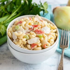 This Crab Macaroni Salad recipe is the perfect way to make a traditional macaroni salad extra special! A creamy, delicious mac salad with crunchy celery, onions and meaty chunks of crab meat (or imitation crab meat). You'll want to make this family favorite again and again!