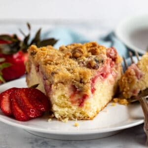 This homemade Fresh Strawberry Cake Recipe is the ultimate way to use all those fantastic strawberries that are currently in season. It's very easy to make from scratch and comes out delicious every single time with tons of delicious strawberries and a crumb topping that can't be beat!