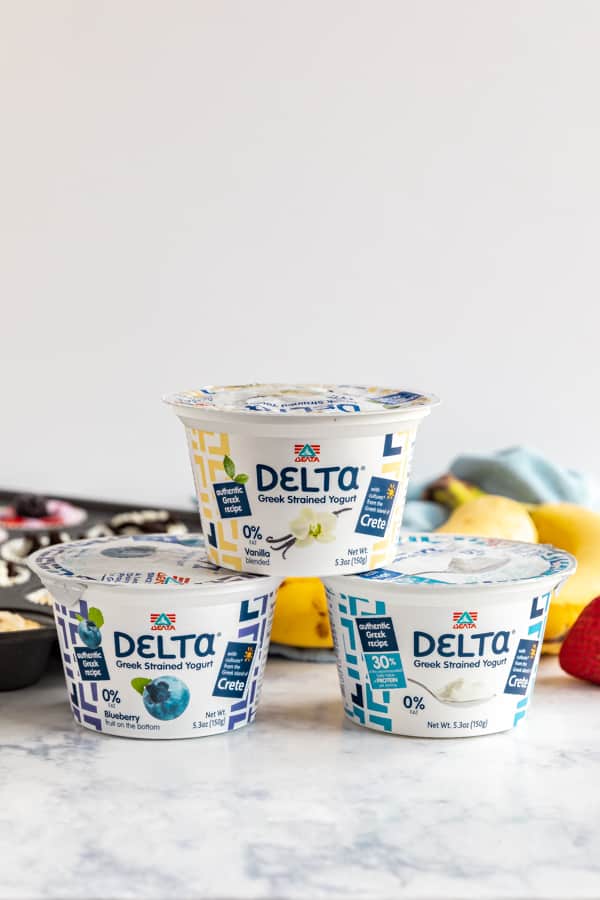 3 Delta Yogurt containers stacked on each other.
