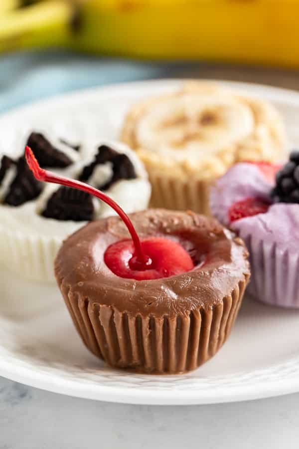 A close up image of the yogurt bites on a plate with the chocolate cherry up front.