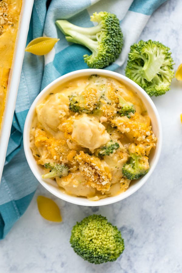 An overhead image of a bowl with broccoli macaroni and cheese.