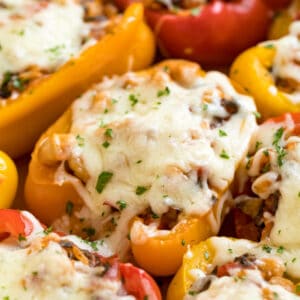 Vegetarian Stuffed Peppers are a healthy, satisfying meal that comes together quickly! This easy weeknight dinner recipe is perfect for Meatless Monday and full of rice, veggies, cheese and Italian-inspired flavors!