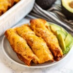 These Easy Chicken Enchiladas recipe may not be the most authentic, but they are seriously delicious and come together really quickly! They're cheesy with shredded chicken and an easy red sauce- the perfect weeknight meal!