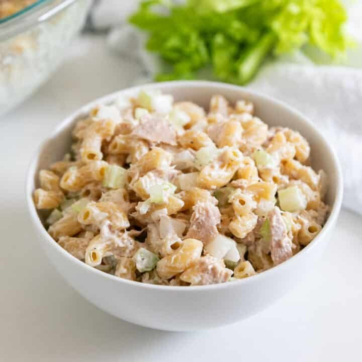 A white bowl full of classic tuna macaroni salad.