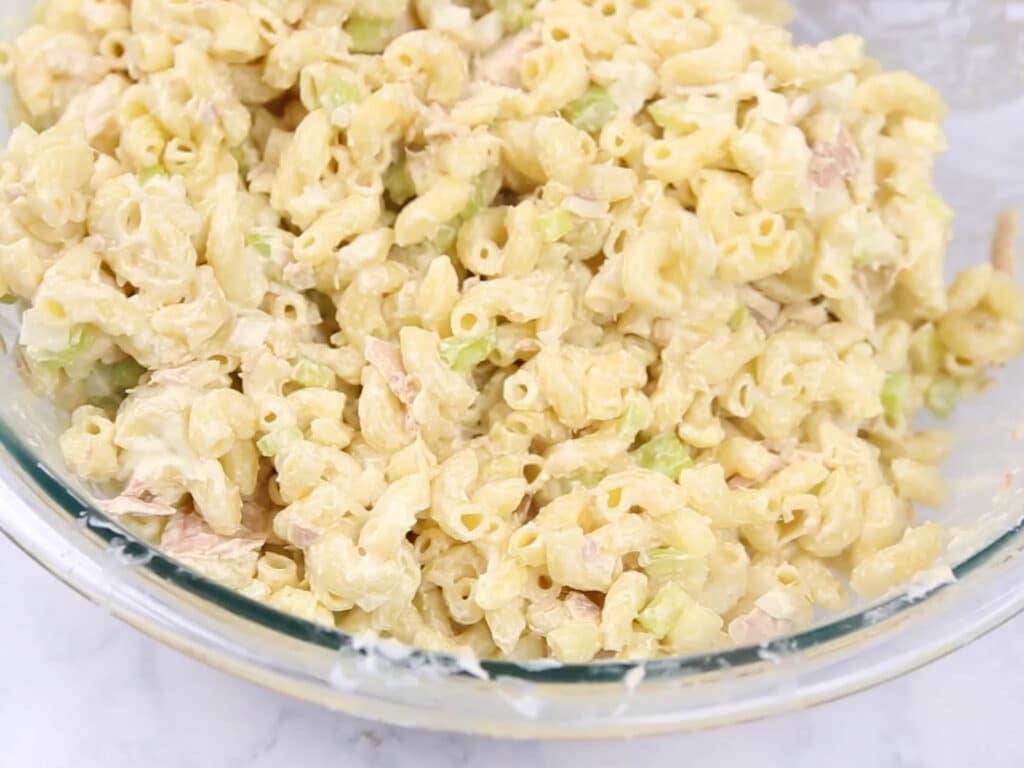 A mixing bowl with all the ingredients for Tuna Mac salad in it