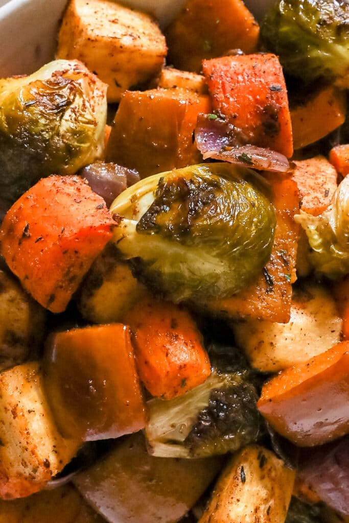 A close up image of roasted veggies piled into a bowl.