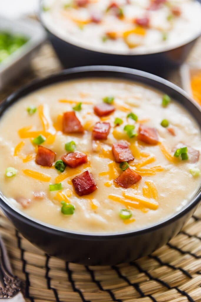 A close up image of a bowl of potato ham soup.