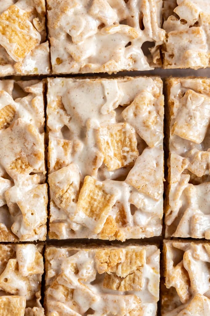 A close up overhead shot of cinnamon treat bars that are cut into pieces.
