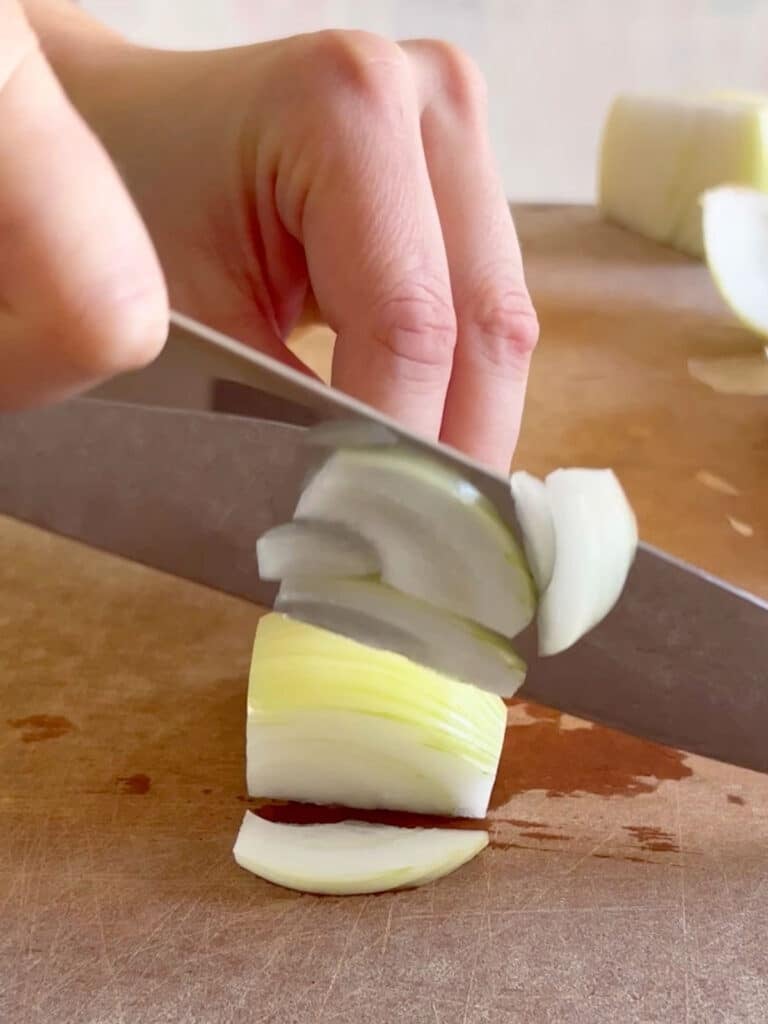 A knife slicing an onion.