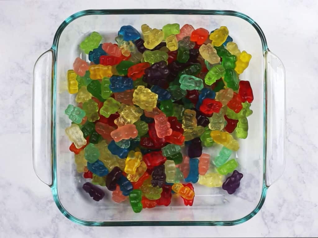 An overhead image of gummy bears in a shallow glass container.