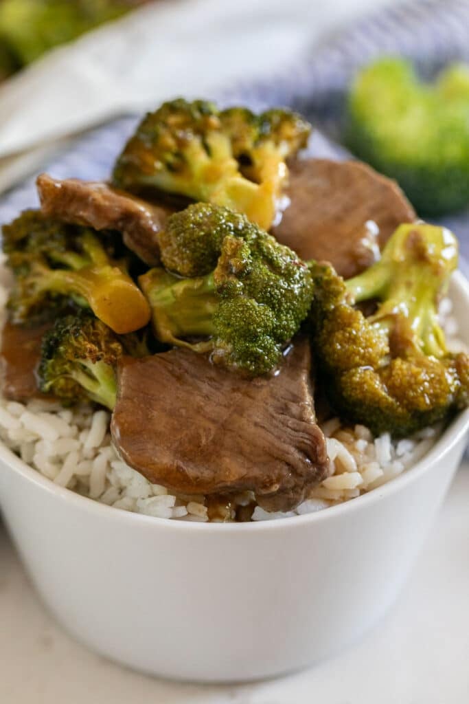 A close up image of a bowl of beef and broccoli.
