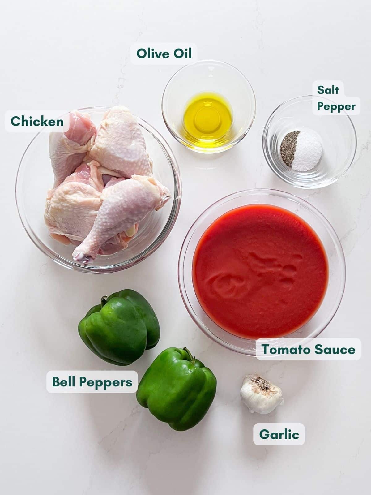 An overhead image of thicken cacciatore ingredients labeled in cler bowls.