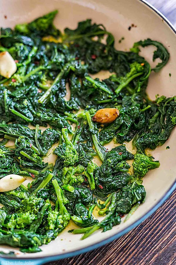 overhead: broccoli rabe with garlic showing about three quarters of a pan