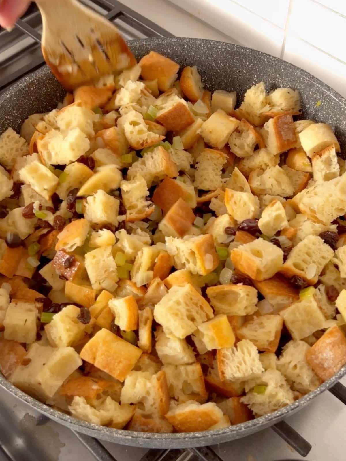 Bread and remaining stuffing ingredients combined in the skillet.