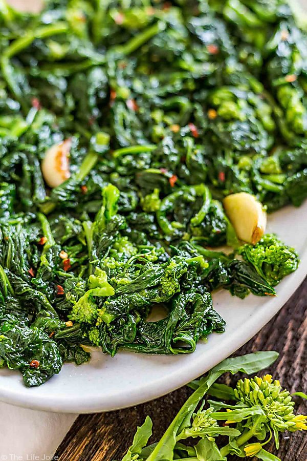 closeup: recipe for broccoli rabe on a plate with garlic showing