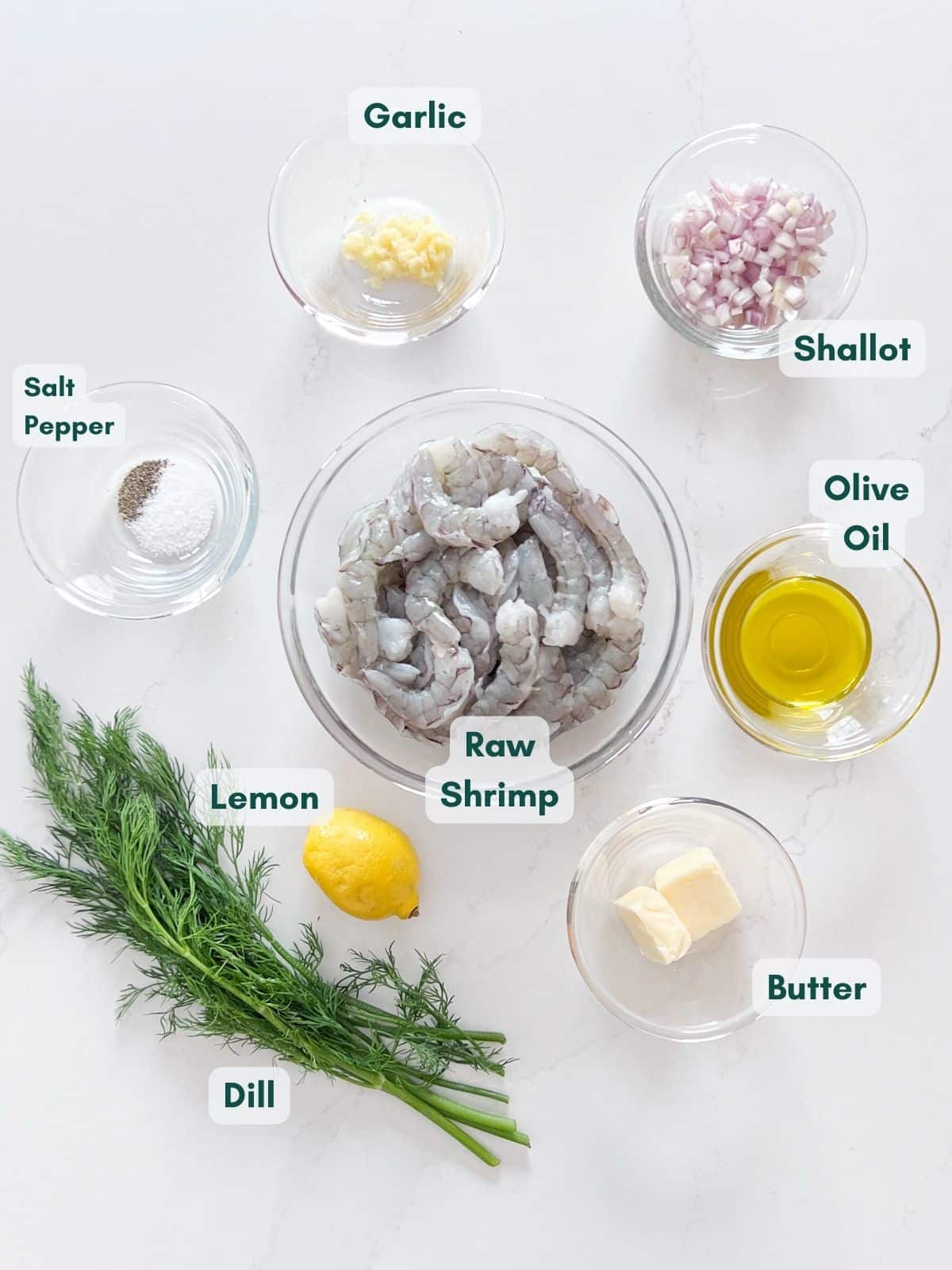 An overhead image of labeled ingredients in glass bowls.