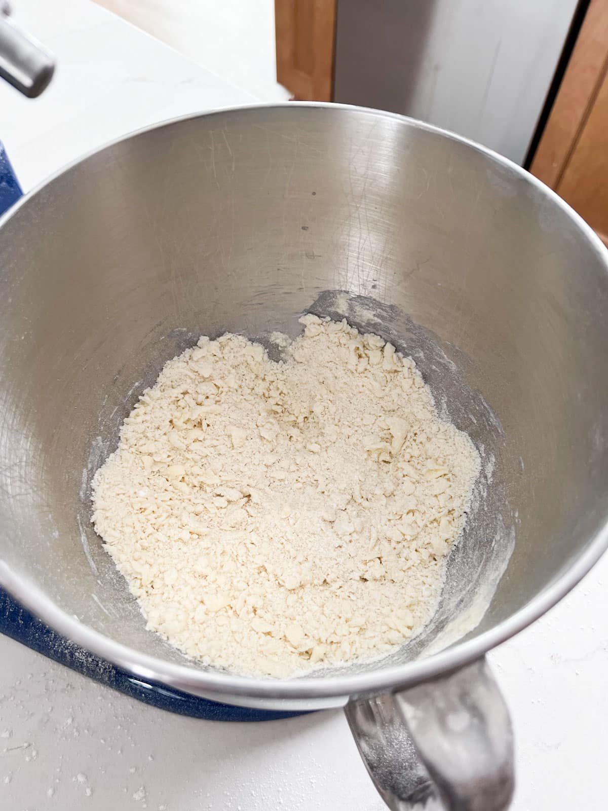 A mixing bowl of the cookie crust mixture.