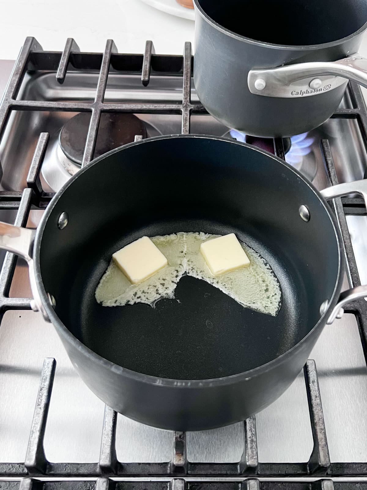 Butter melting in a sauce pan on the stove.