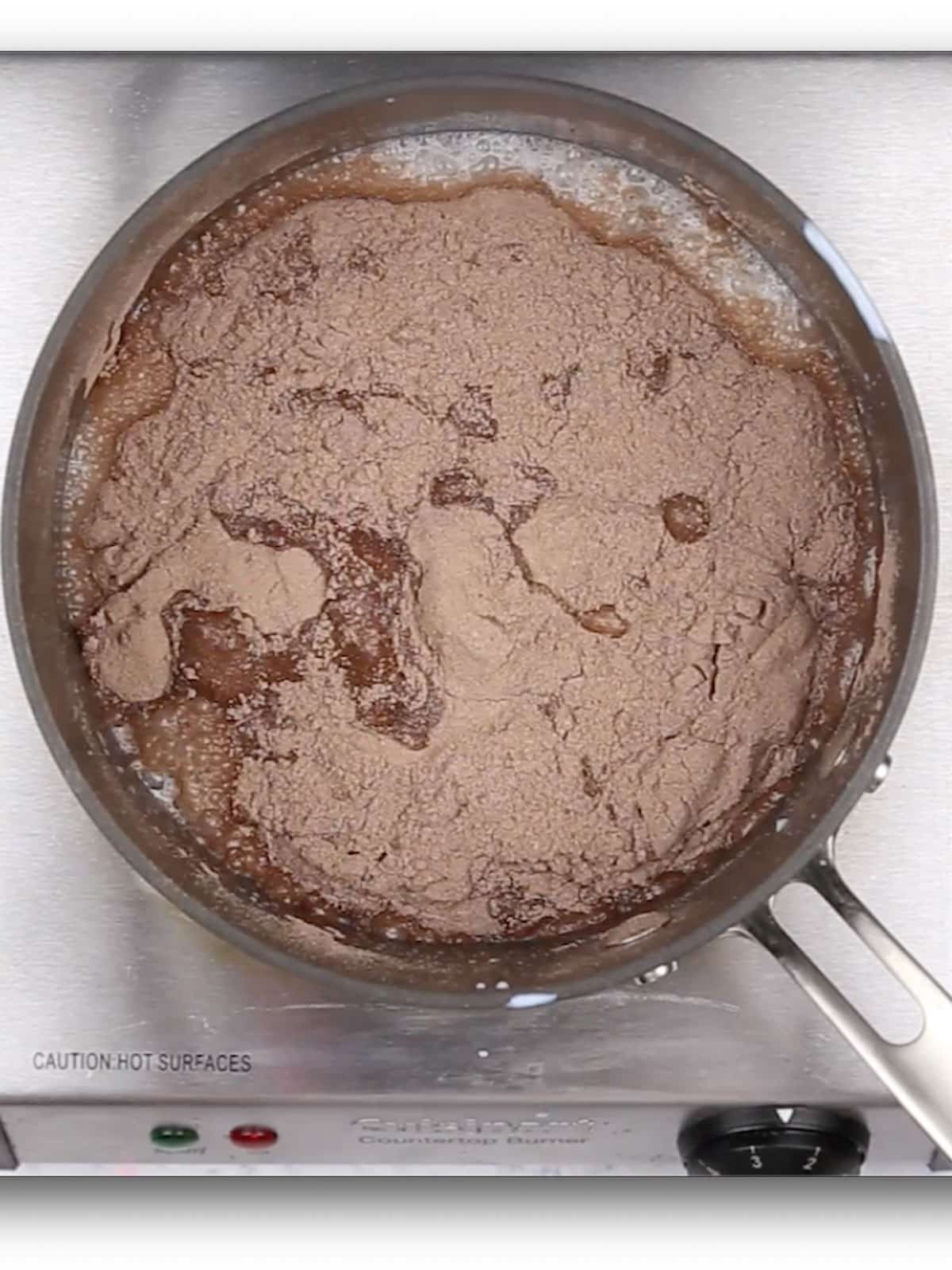 An overhead image of a pan with milk and pudding mix in it.