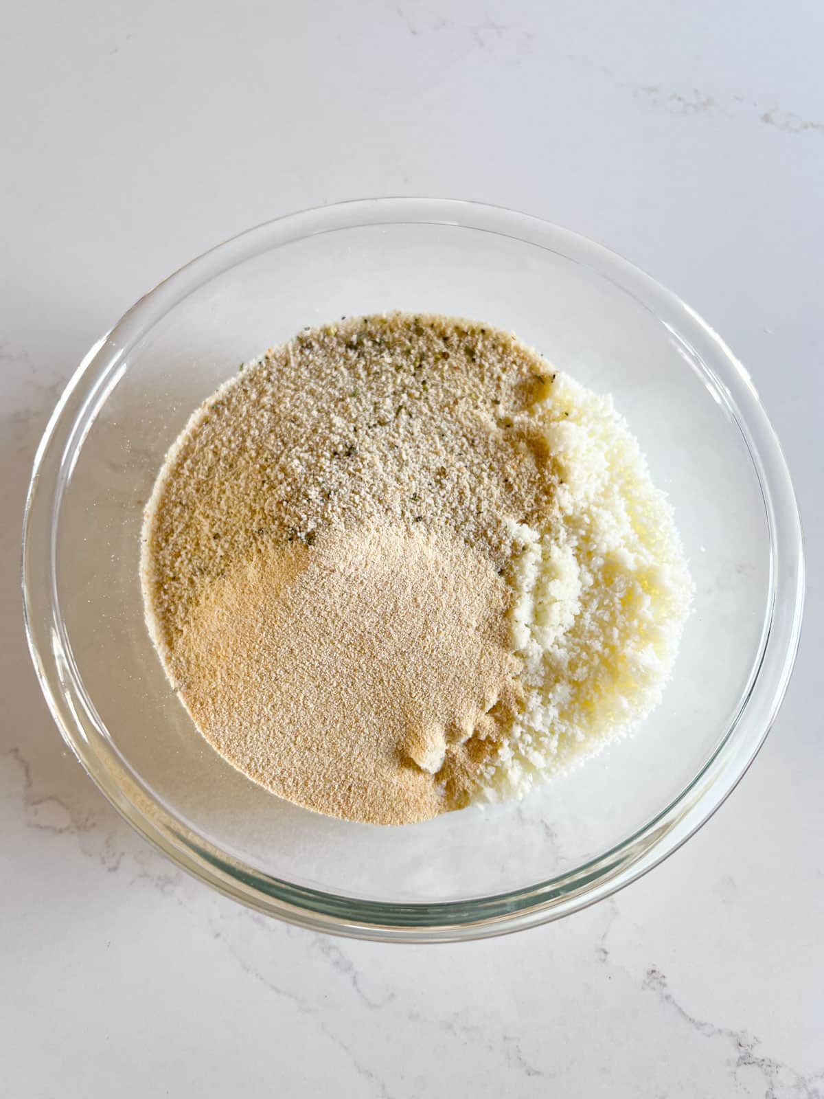 Dry ingredients placed in a glass bowl.