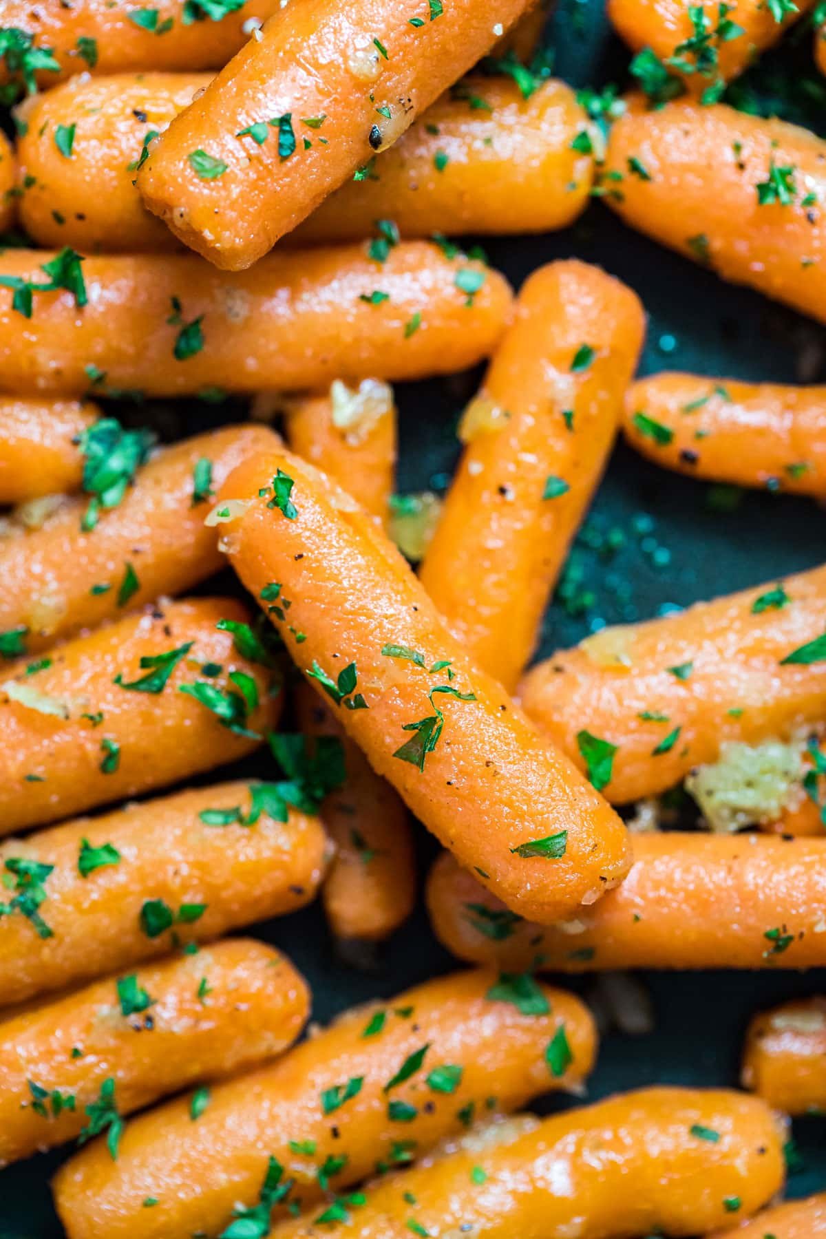 A close up overhead image of the sauteed carrots in a pan.