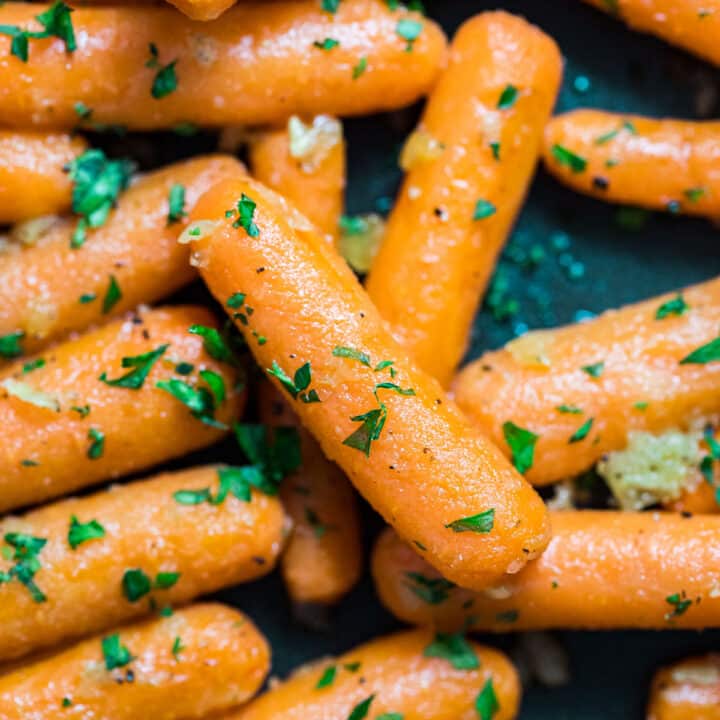 A close up overhead image of the sauteed carrots in a pan.