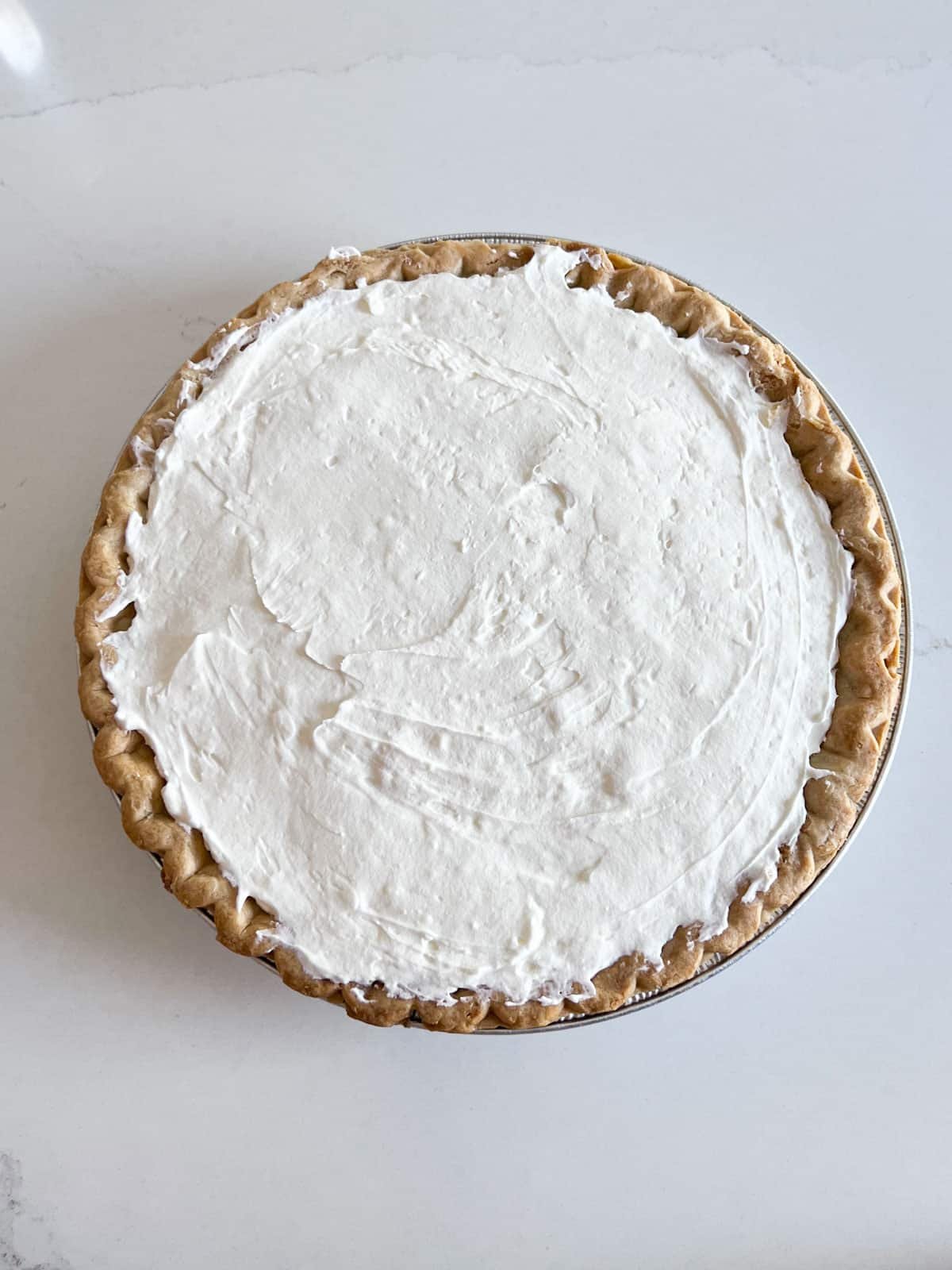 Cream cheese mixture spread in the baked pie shell.