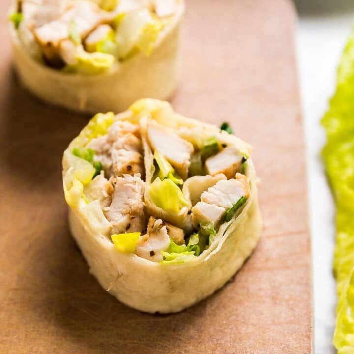 Close up image of Caesar pinwheels on a cutting board.