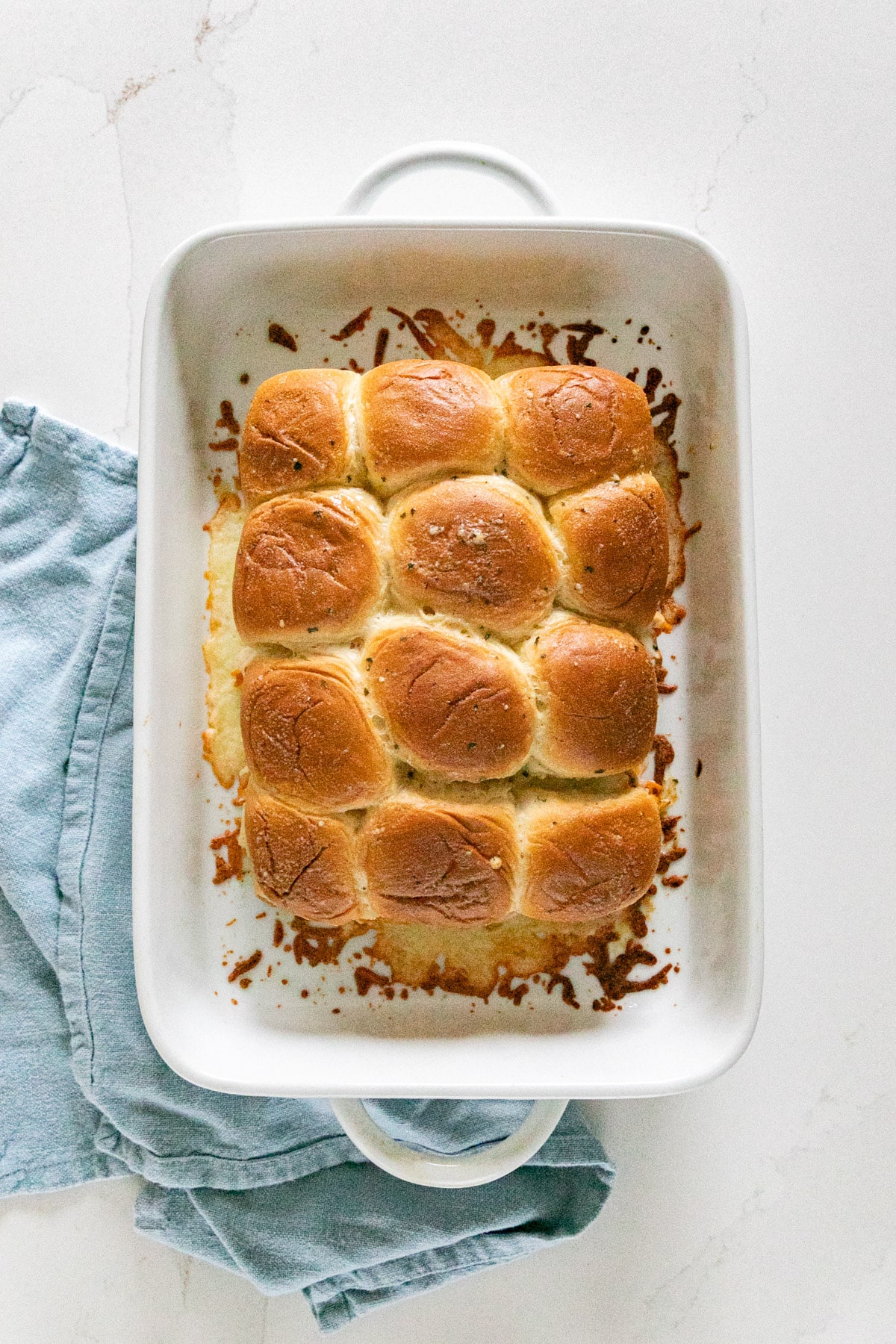 An overhead image of buffalo sliders in a pan.