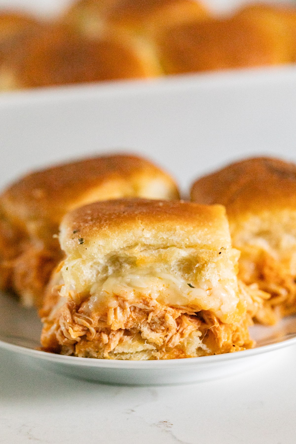 Buffalo sliders on a plate.