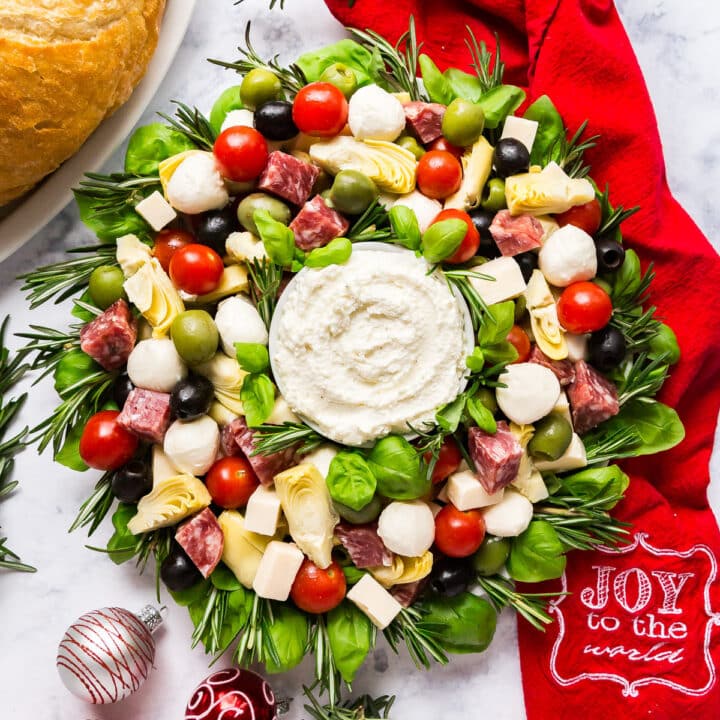 An overhead image of an Antipasto Appetizer recipe in the shape of a Christmas wreath.