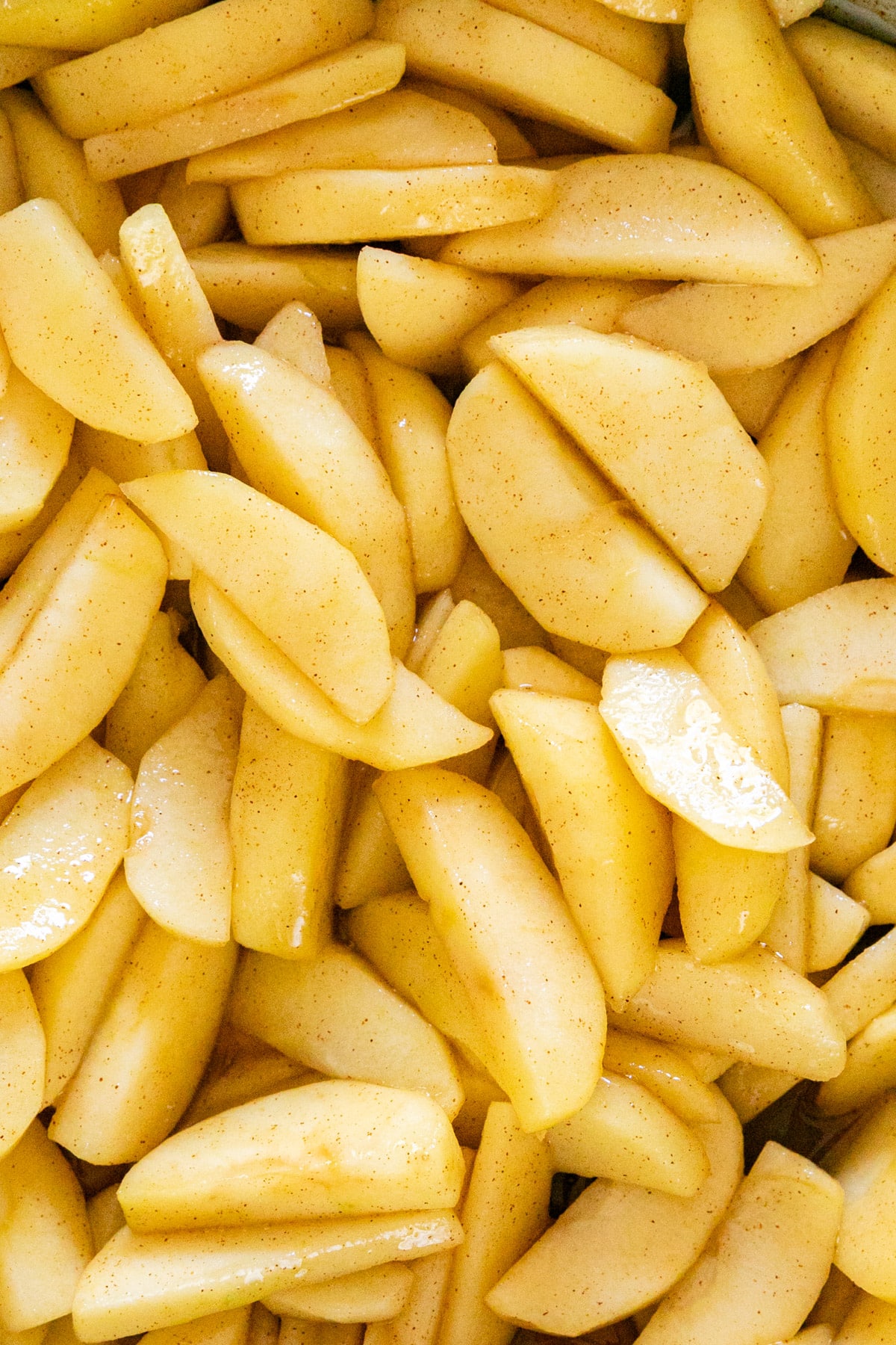A close up overhead image of apple pie filling.