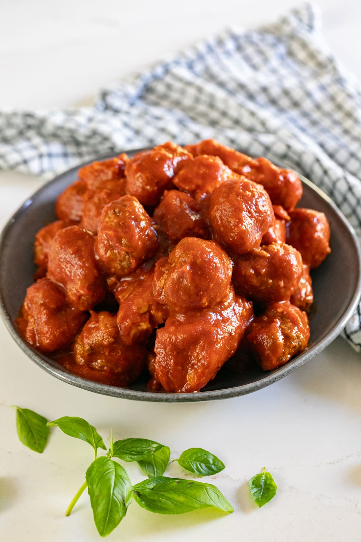 A bowl of meatballs in sauce with pork in sauce.