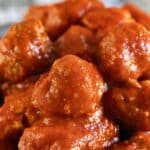A pile of homemade meatballs in tomato sauce.