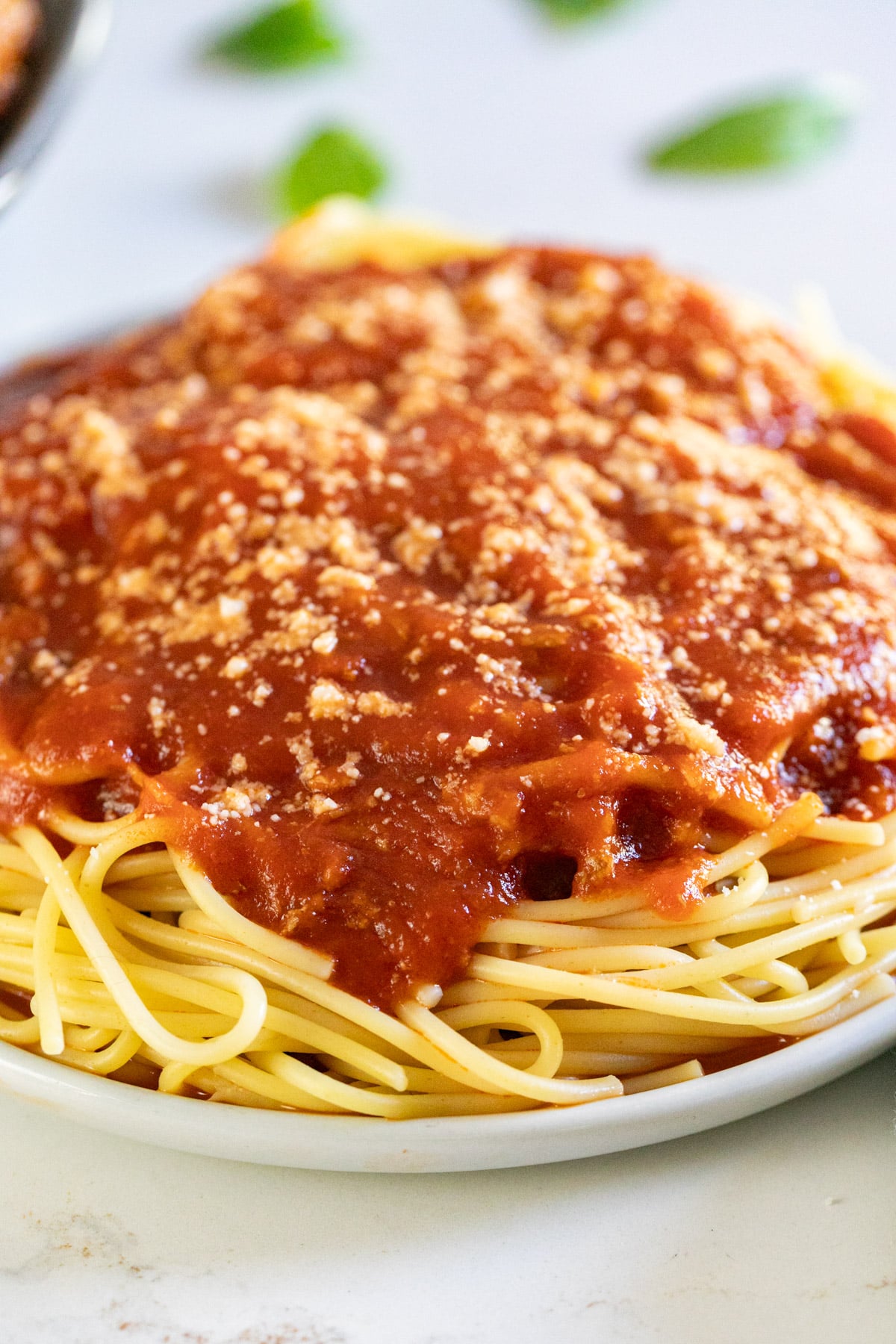 A close up of meat sauce on a bed of spaghetti.