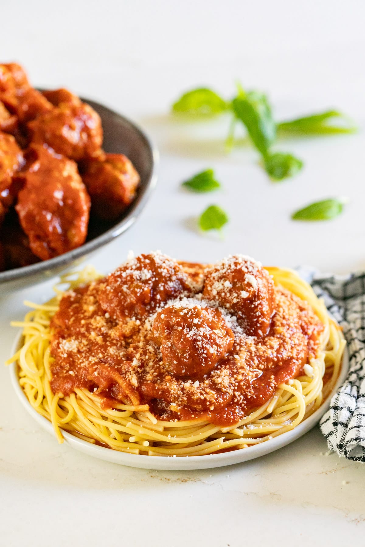 A plate of spaghetti with meatballs and sauce on it.