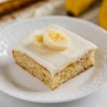 A slice of banana bread bar on a white plate.