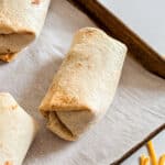 A bean burrito on a sheet pan.