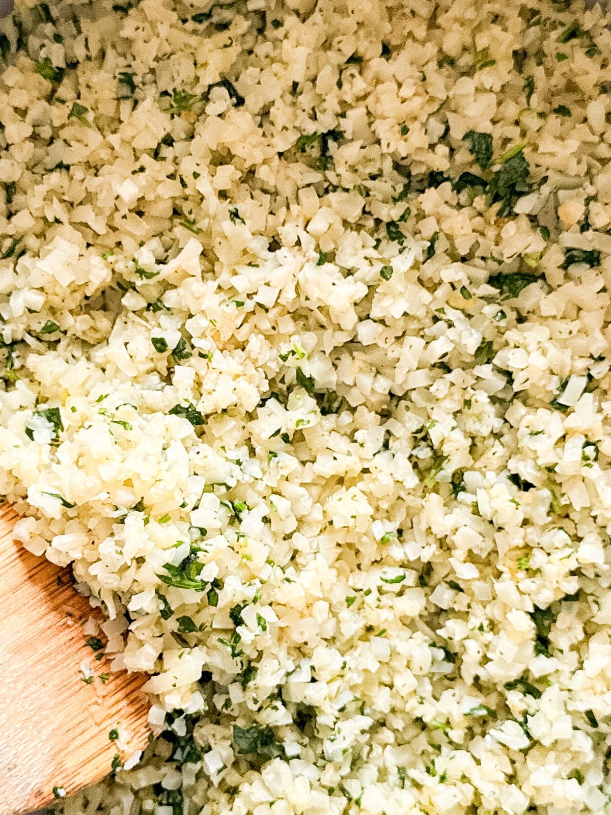 A close up image of cauliflower rice in a pan.