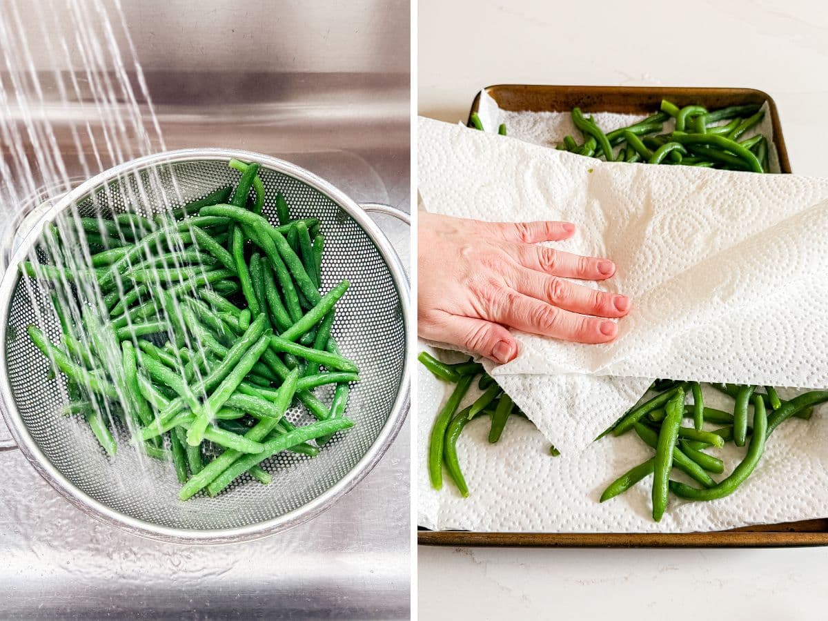 Blanched green beans under cold water and then being dried with paper towels on a sheet pan.