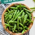 An overhead image of green bean salad in a wooden bowl.