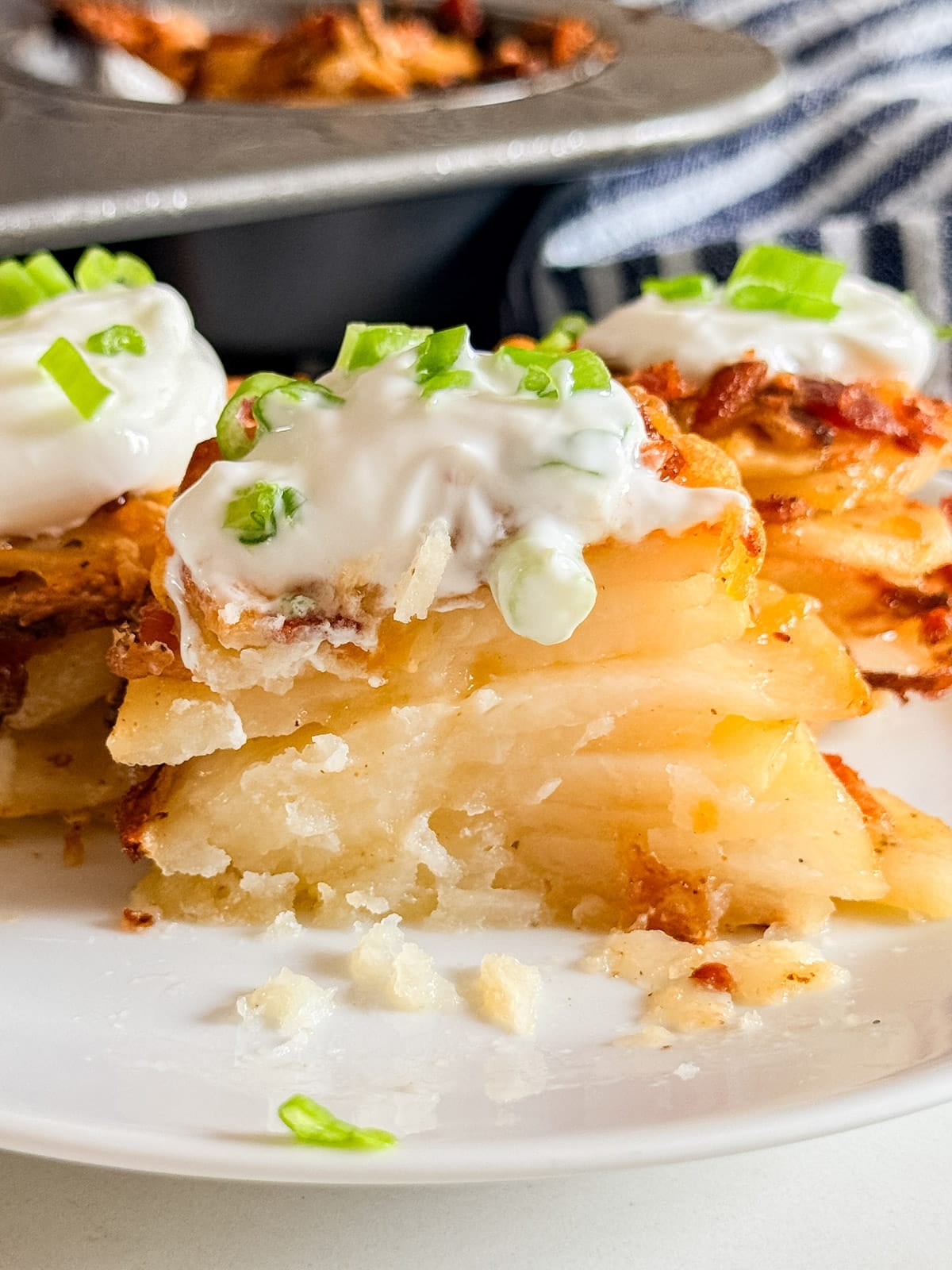 A close up of a potato stack cut in half revealing the fluffy cooked inside of the potatoes.